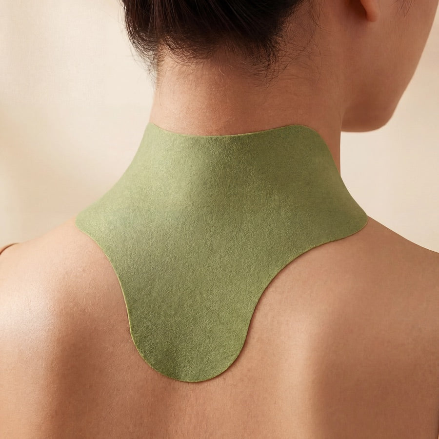 NeckReset heat patch applied to neck and shoulders